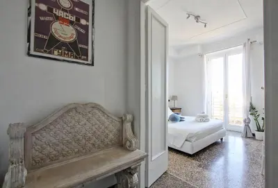 a living room with a bench and a bed in it at BigFamilyRome - San Giovanni Basilica in Rome