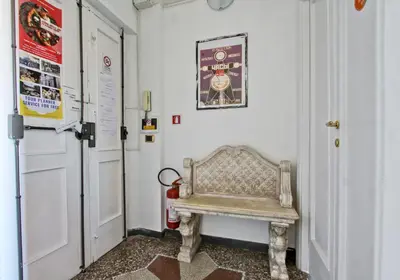 a hallway with a bench in a room with a door at BigFamilyRome - San Giovanni Basilica in Rome