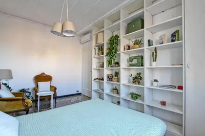 a room with a bed and shelves with plants at BigFamilyRome - San Giovanni Basilica in Rome