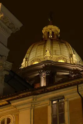 a building with a dome on top at night at San Carlo Suite in Rome