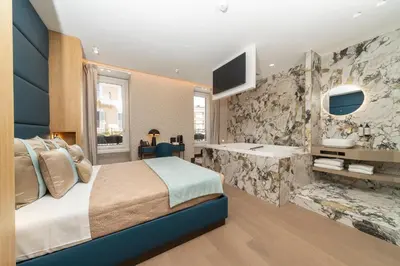 a bedroom with a king sized bed and a tv at San Carlo Suite in Rome