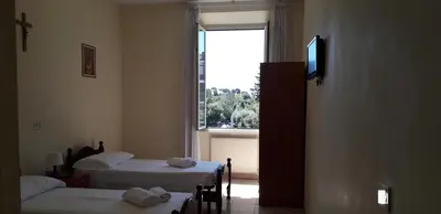 a room with two beds and a window at Ostello Villa Monte Mario in Rome