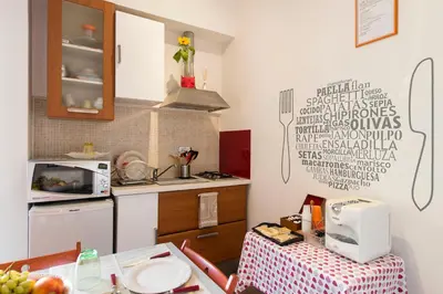 a small kitchen with a table and a microwave at B&B Blueberry Rooms in Rome