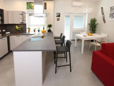a kitchen and dining room with a table and chairs at Appartamento Turistico Laura in Rome