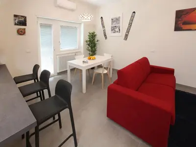 a living room with a red couch and a table at Appartamento Turistico Laura in Rome