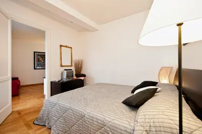 a bedroom with a bed and a lamp at Romacentrarte in Rome