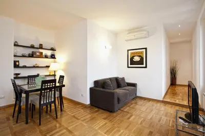 a living room with a table and a chair and a couch at Romacentrarte in Rome