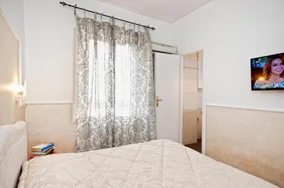 a bedroom with a bed and a tv on a wall at Romacentrarte in Rome