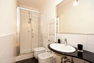 a bathroom with a sink and a shower and a toilet at Romacentrarte in Rome