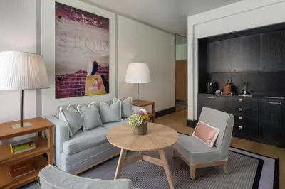 a living room with a couch and a table and chairs at Portrait Roma - Lungarno Collection in Rome