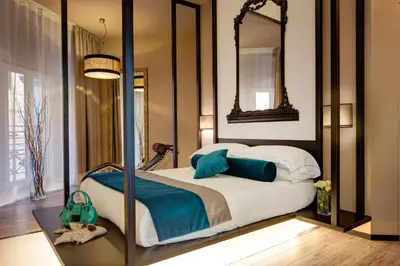 a bedroom with a bed with a mirror at Dharma Luxury Hotel & SPA in Rome