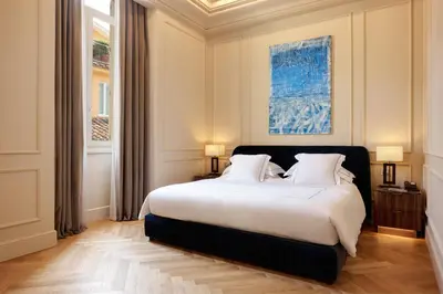 a bedroom with a large white bed with two lamps at The First Arte - Preferred Hotels & Resorts in Rome