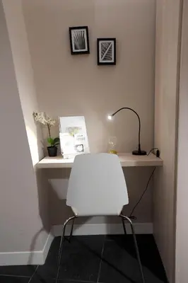 a white desk with a lamp and a white chair at Suite 21 - Piazza Navona in Rome