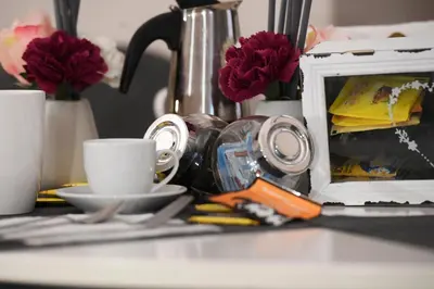 a table with a coffee maker and cups and flowers at Suite 21 - Piazza Navona in Rome