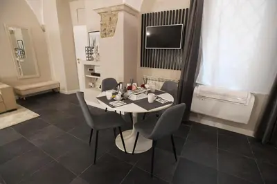 a small dining room with a table and chairs at Suite 21 - Piazza Navona in Rome