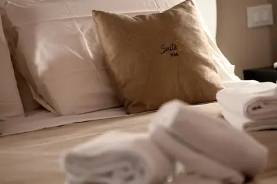 a bed with a pillow and towels on it at Suite 21 - Piazza Navona in Rome