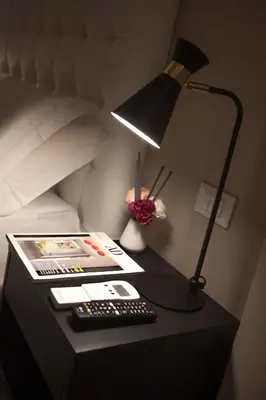 a desk with a lamp and a keyboard and a remote control at Suite 21 - Piazza Navona in Rome