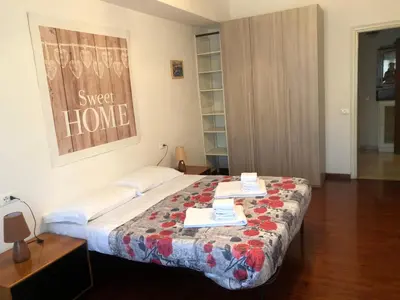 a bedroom with a bed with a quilt on it at The Colours Of Rome in Rome