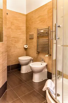 a bathroom with two toilets and a sink at The Colours Of Rome in Rome