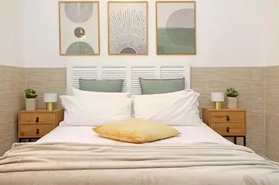 a white bed with a yellow pillow on it at Opera Inn Suites - Rooms and Apartments in Rome