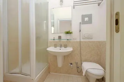 a bathroom with a shower and a sink and a toilet at Opera Inn Suites - Rooms and Apartments in Rome