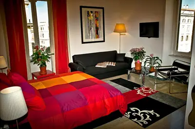 a living room with a colorful bed and a couch at Vatican Paradise in Rome