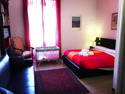 a bedroom with two beds and a window at Vatican Paradise in Rome