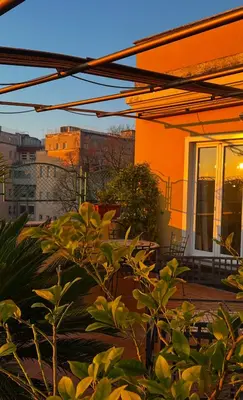 an orange house with a patio with plants at All Comfort Astoria Palace in Rome