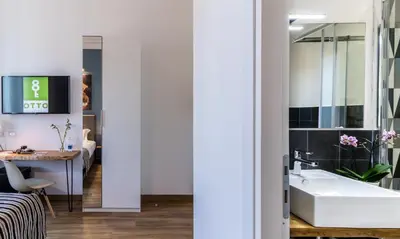 a bathroom with a sink and a table in a room at OTTO Rooms & Photogallery in Rome