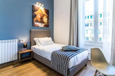 a small bedroom with a bed and a window at OTTO Rooms & Photogallery in Rome