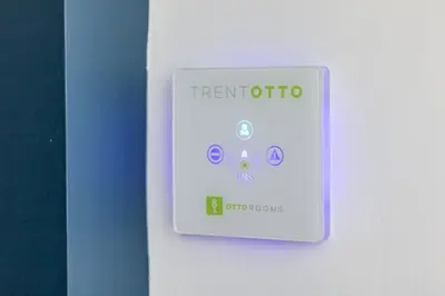 a white lightswitch on a wall with the words transmitatio at OTTO Rooms & Photogallery in Rome