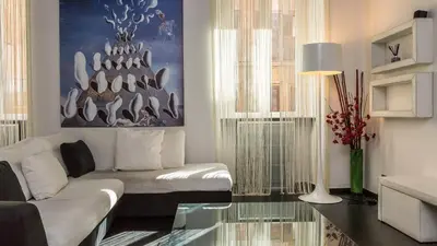 a living room with a white couch and a glass table at Rental in Rome Cosmopolitan hi-tech in Rome