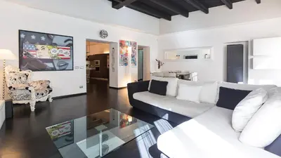 a living room with a couch and a glass table at Rental in Rome Cosmopolitan hi-tech in Rome