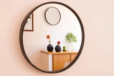 a round mirror hanging on a wall in a room at ROMAC Condotti with 3 bedrooms near the Spanish Steps in Rome