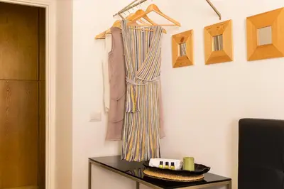 a room with a table and a curtain hanging on a wall at ROMAC Condotti with 3 bedrooms near the Spanish Steps in Rome