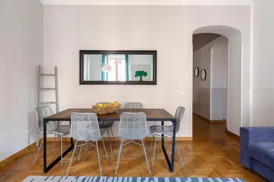 a dining room table with chairs and a mirror on the wall at ROMAC Condotti with 3 bedrooms near the Spanish Steps in Rome
