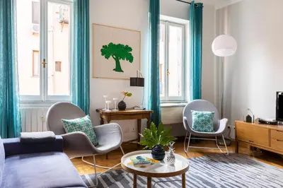a living room with a blue couch and chairs at ROMAC Condotti with 3 bedrooms near the Spanish Steps in Rome