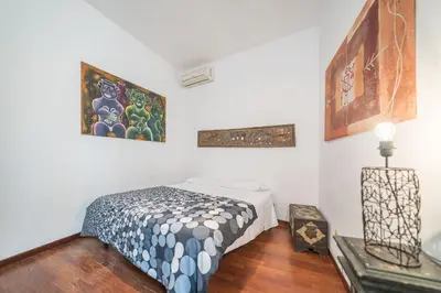 a bedroom with a bed and paintings on the wall at Panetteria Apartment in Rome