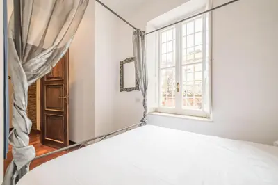 a bedroom with a bed and a window at Panetteria Apartment in Rome