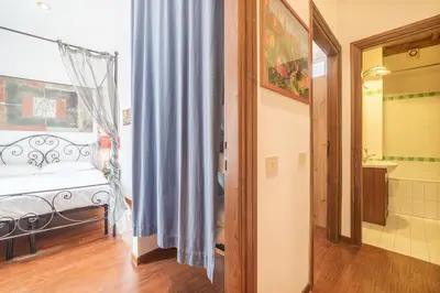 a bedroom with a bed and a bathroom with a window at Panetteria Apartment in Rome