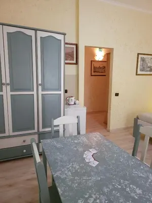 a dining room with a table and chairs and a room at St. Peter's Rooms Rome in Rome