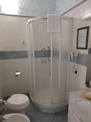 a bathroom with a shower and a toilet and a sink at St. Peter's Rooms Rome in Rome