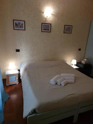 a bedroom with a bed with two towels on it at St. Peter's Rooms Rome in Rome