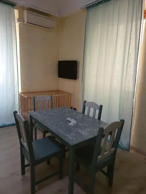 a dining room table with chairs and a television at St. Peter's Rooms Rome in Rome