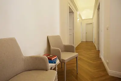 two chairs and a table in a hallway at Luxury & Charme Colosseo in Rome