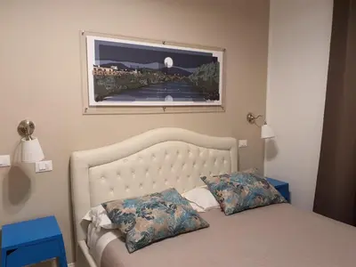 a bedroom with a bed with a picture on the wall at Luxury & Charme Colosseo in Rome