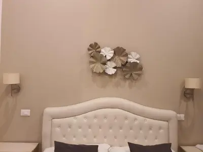 a bedroom with a bed with two flowers on the wall at Luxury & Charme Colosseo in Rome