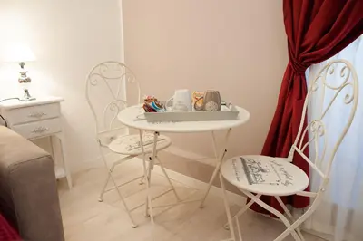 a white table and two chairs in a room at Lifestyle Veneto Suite in Rome