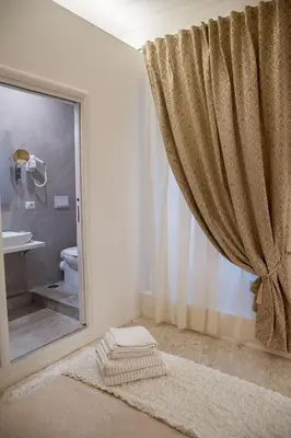a bathroom with a toilet and a shower with a window at Lifestyle Veneto Suite in Rome