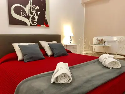 a bedroom with a red bed with towels on it at Lifestyle Veneto Suite in Rome